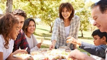 Happy multi generation family having a picnic in a park